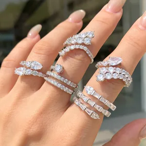 Detailed macro view of five sterling silver rings with sparkling zircon stones on fingers