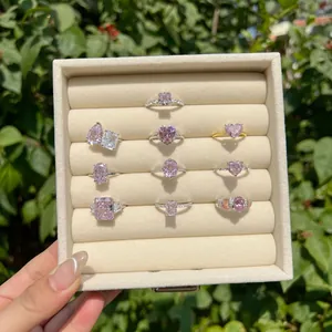 Variety of pink crushed ice cut cubic zirconia rings displayed in a jewelry box.