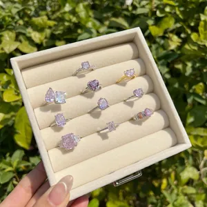 Close-up of elegant S925 silver rings with pink cubic zirconia in a jewelry box