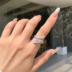 Close-up detail of a layered sterling silver ring with sparkling cubic zirconia on a hand