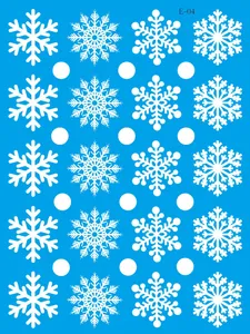 Detailed view of white snowflake patterns on blue Christmas static window decals.