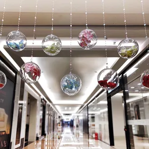 Transparent hanging plastic spheres with colorful flowers for festive mall interior decoration