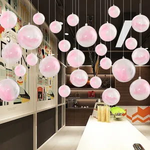 Clear plastic hanging spheres with soft pink feathers for festive mall shop decor