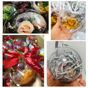 Detail view of various clear plastic ornaments with decorative flower and ribbon fillers