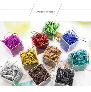 Various colors of glitter shredded raffia grass filler displayed in acrylic boxes