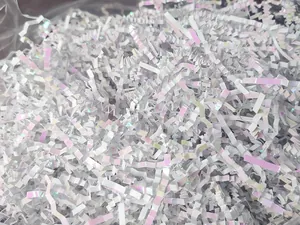 Close-up of iridescent crinkle cut paper shreds for gift box packaging filler.