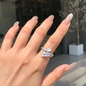 Close-up of a sparkling S925 sterling silver ring with pear-shaped zirconia on a hand.