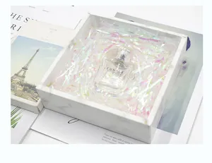 Macro view of iridescent shredded paper filler inside a marble pattern gift box