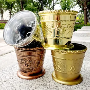 Set of four metallic finish Christmas tree stands and decorative flower pots.