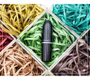Macro view of vibrant multi-colored glitter raffia grass shredded filler for gift boxes
