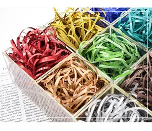 Detail view of colorful glitter shredded raffia used as sparkling gift box filler decorations.