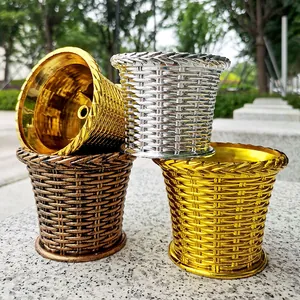 Detailed view of metallic woven texture flower pots in gold, silver, and bronze finishes