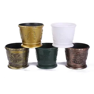 Close-up of five plastic Christmas flower pots with embossed festive patterns