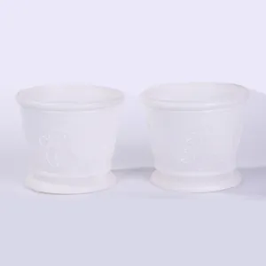 Pair of white plastic Christmas pots featuring embossed snowman and tree relief patterns