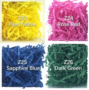 Detailed macro view of colorful crinkle cut paper shred gift box filler in four shades