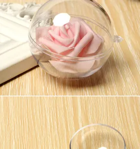 Close-up detail of clear acrylic ornament ball containing a decorative pink rose