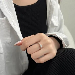 Close-up of elegant S925 sterling silver solitaire ring on model's finger