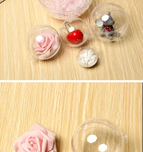 Macro view of clear hollow plastic decorative balls containing rose and props