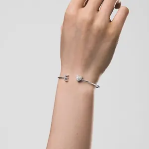 Detail eines S925 Sterling Silber Armreifs mit einem Herz und dem Buchstaben E Anhänger