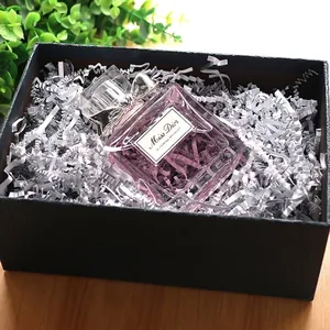 Premium white crinkled shredded paper filler for gift boxes and product packaging display.