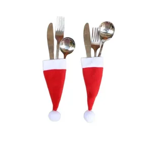 Two pieces of mini Santa hat cutlery holders for festive Christmas dinner table decoration