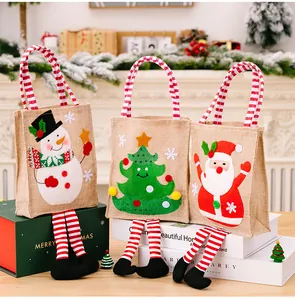Set of three Christmas burlap gift bags with cartoon prints and striped hanging legs