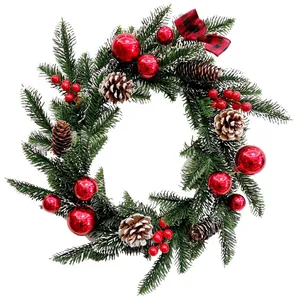Lush Christmas wreath featuring red baubles, natural pine cones, and a festive plaid bow