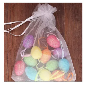 Colorful glitter Easter foam eggs in a white organza bag for festive holiday decoration.
