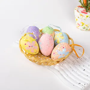 Close-up view of colorful foam Easter eggs with hanging ribbons in a small basket.