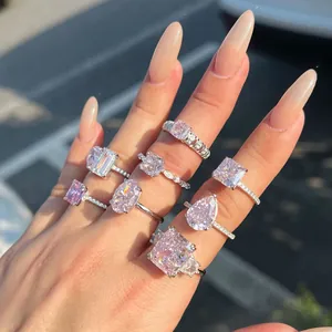 Gros plan détaillé de huit bagues de luxe en zircon rose sur une main sous la lumière du soleil