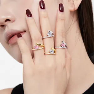 Detailed macro shot of luxury pear-cut pink and white CZ wrap rings worn on a hand