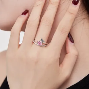 Close-up of S925 silver ring featuring a pink ice-cut heart zircon on a model's hand