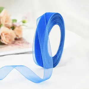 Close-up detail of royal blue sheer chiffon ribbon for gift wrapping and DIY crafts.