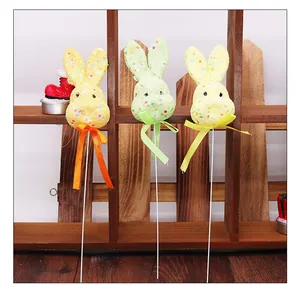 Detailed view of three colorful Easter foam bunny decorative picks with ribbon bows