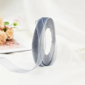 Close-up of translucent grey chiffon ribbon roll with elegant texture for gift wrapping