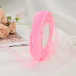 Close-up of pink sheer chiffon ribbon roll for gift wrapping and cake decoration