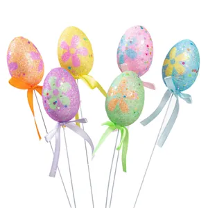 Colorful glitter Easter egg picks with floral patterns and ribbon bows for decor