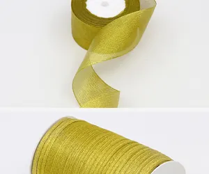 Detailed view showing the texture of shimmering gold metallic ribbon for gift packaging