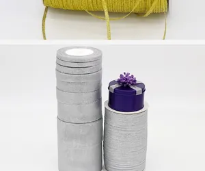 Detailed macro view of stacked gold and silver glitter ribbons for festive gift packaging
