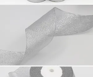 Close-up macro view of high-quality shimmering silver glitter ribbon for festive gift wrapping
