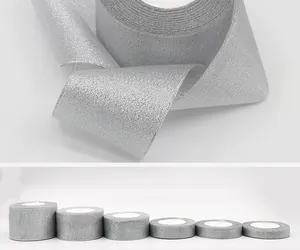 Macro view of silver glitter ribbon texture and rolls in various widths