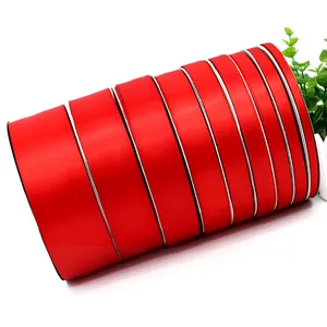 Vibrant red double-sided polyester satin ribbon rolls for gift wrapping and DIY crafts.