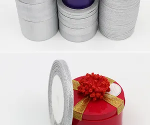 Detailed view of shimmering silver glitter ribbon used for elegant gift box packaging
