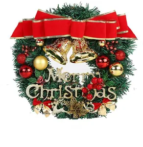 Detailed view of PVC Christmas wreath with red bow, gold bells, and Merry Christmas sign