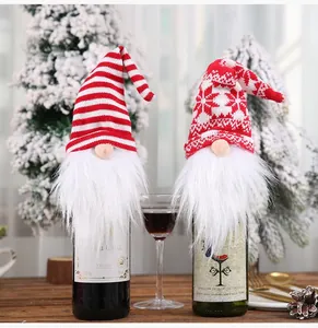 Close-up detail of festive knitted gnome wine bottle covers featuring fluffy white beards
