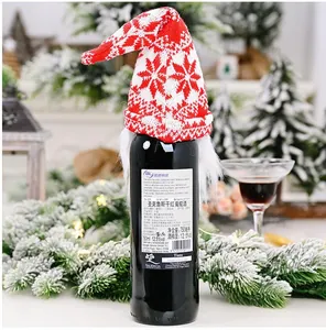 Festive knitted Christmas wine bottle cover gnome hat with white beard and snowflake pattern