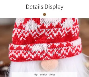 Macro detail of red and white knitted Christmas gnome wine bottle topper decoration