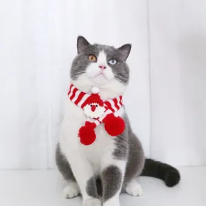 Vue détaillée de l'écharpe de Noël rayée rouge et blanc pour chat avec Père Noël.