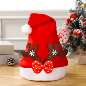 Detail of Christmas Santa hat with reindeer antlers and red polka dot bow decoration