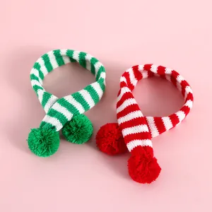 Détail d'écharpes de Noël tricotées à rayures rouges et vertes pour chats avec pompons